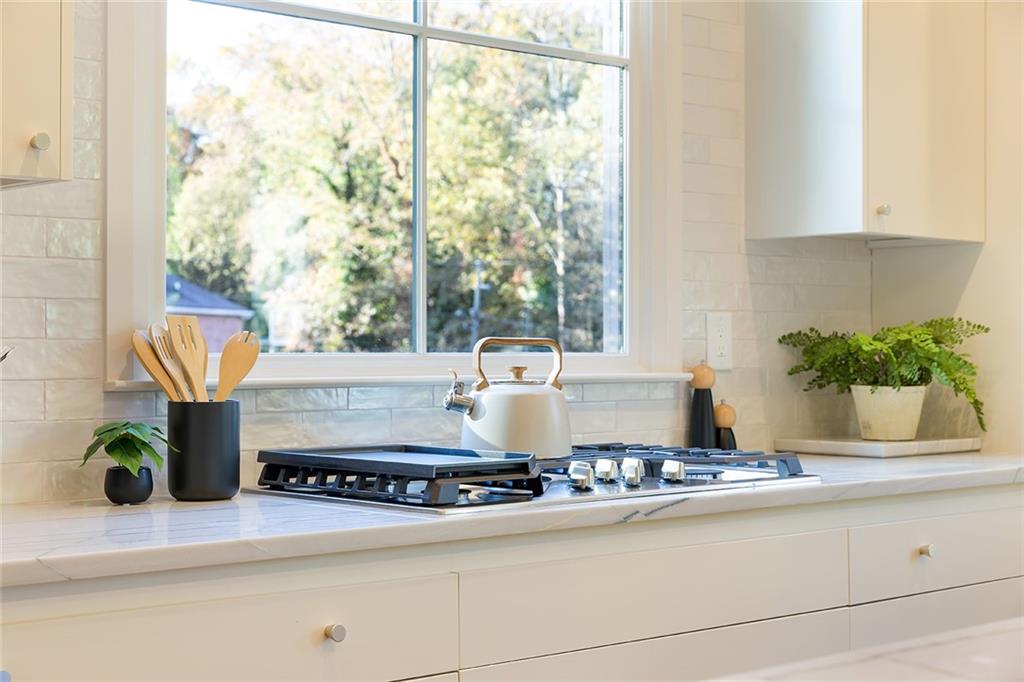 3156 Zion Street Scottdale, GA 30079 - Photo 12 of 40 a table with a potted plant and a stove