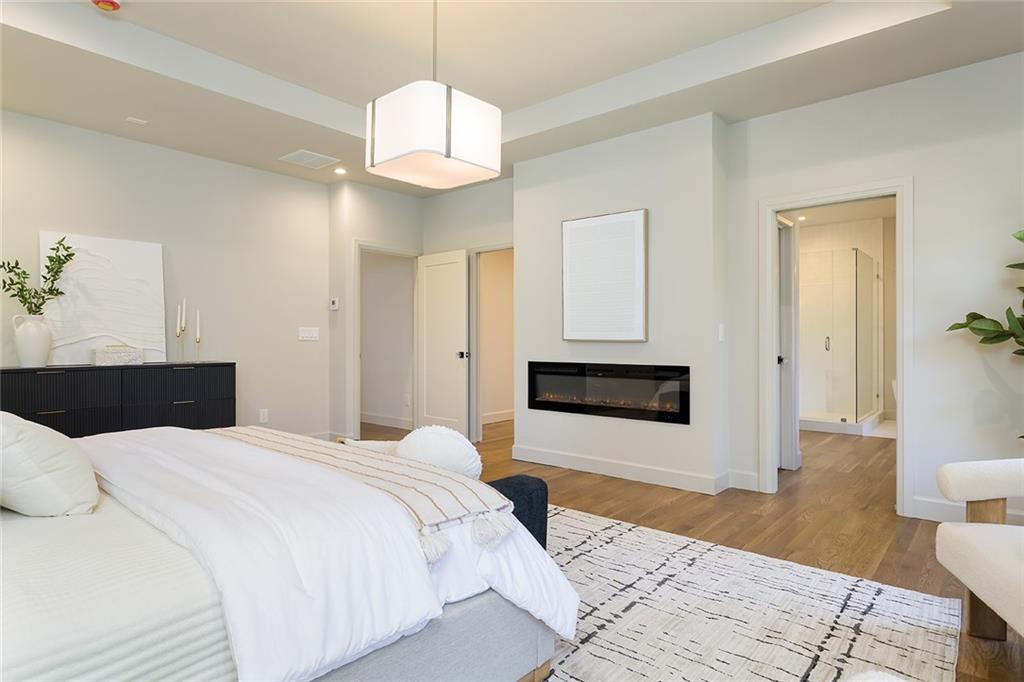 3156 Zion Street Scottdale, GA 30079 - Photo 19 of 40 a spacious bedroom with a large bed and a chandelier