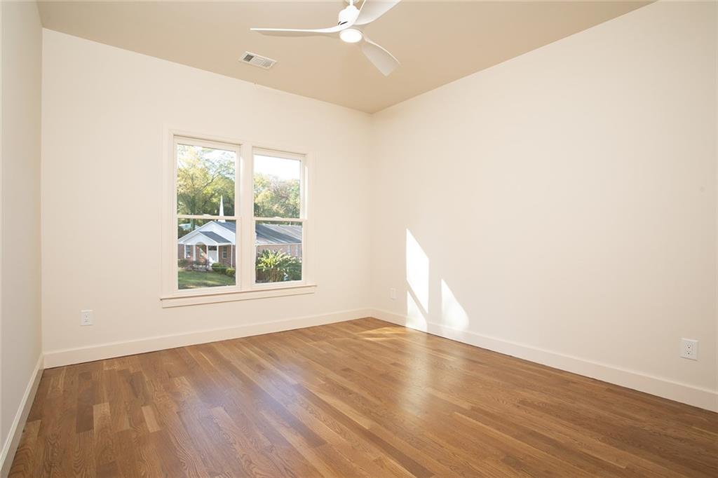 3156 Zion Street Scottdale, GA 30079 - Photo 24 of 40 an empty room with wooden floor and windows