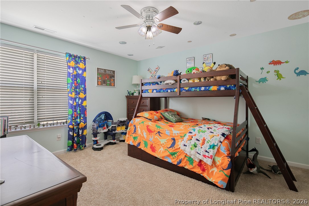 340 Battery Way Bunnlevel, NC 28323 - Photo 33 of 50 a bedroom with a bed and a chandelier