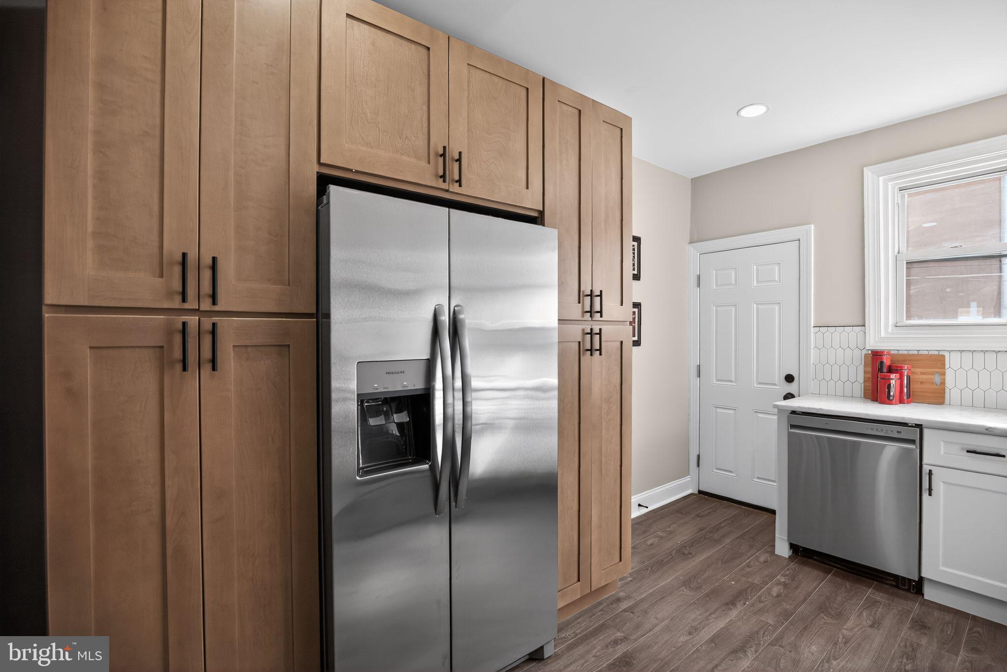 2014 Moore Street Philadelphia, PA 19145 - Photo 11 of 26 a kitchen with stainless steel appliances refrigerator stove and wooden floor