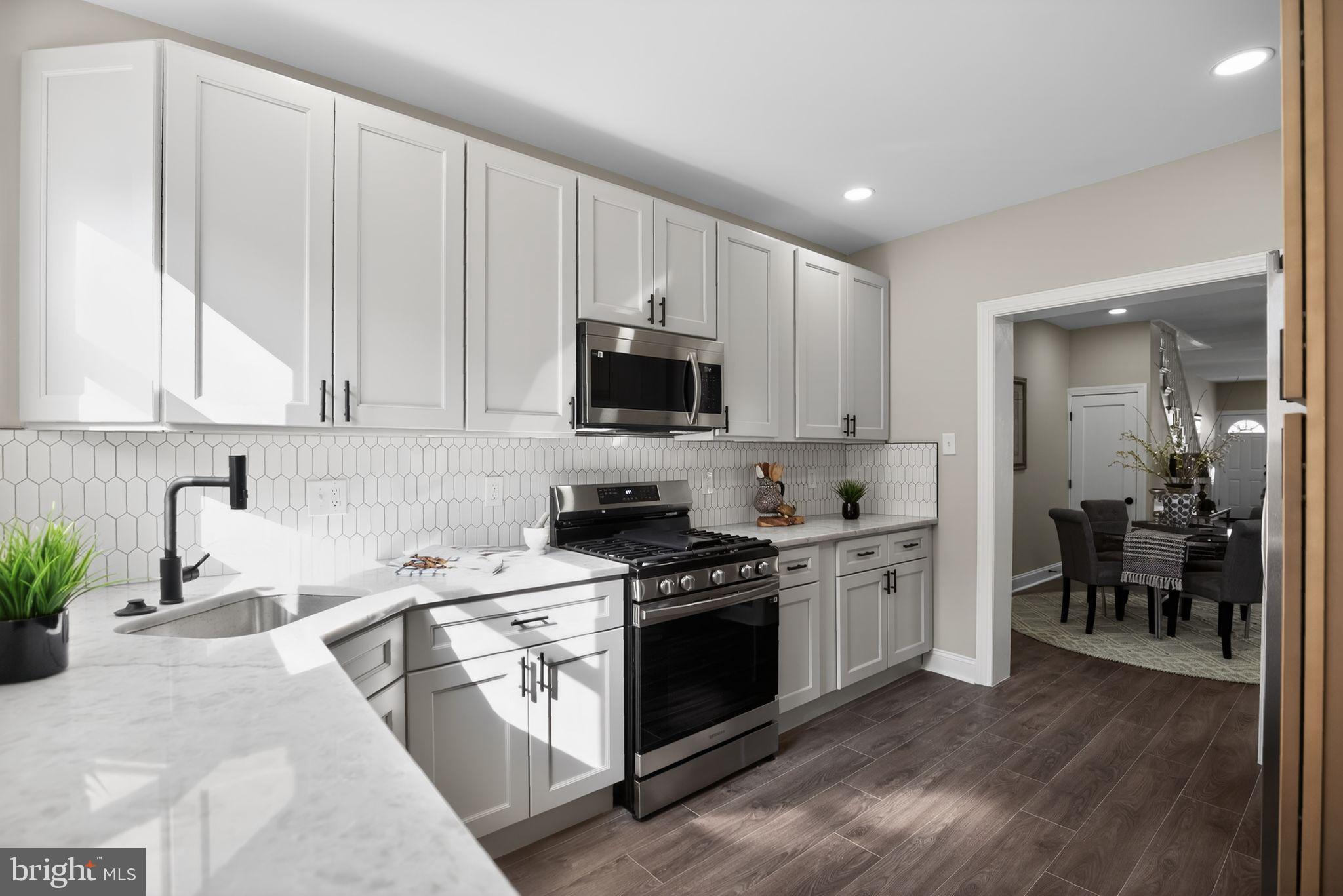 2014 Moore Street Philadelphia, PA 19145 - Photo 13 of 26 a kitchen with stainless steel appliances granite countertop a stove a sink and a microwave