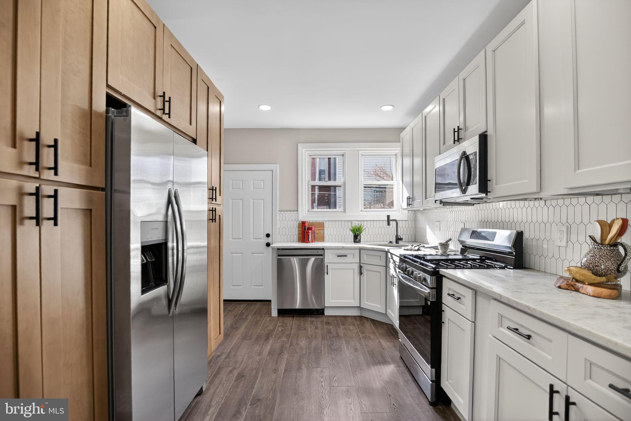2014 Moore Street Philadelphia, PA 19145 - Photo 14 of 26 a kitchen with stainless steel appliances granite countertop a refrigerator a stove top oven a sink and dishwasher