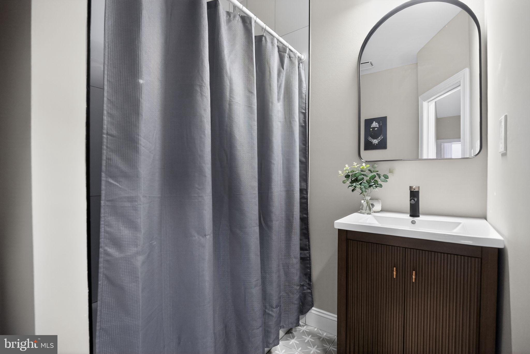 2014 Moore Street Philadelphia, PA 19145 - Photo 19 of 26 a bathroom with a sink a mirror and vanity