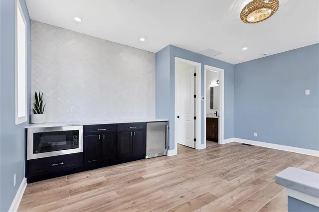 a view of a kitchen with a sink and cabinets