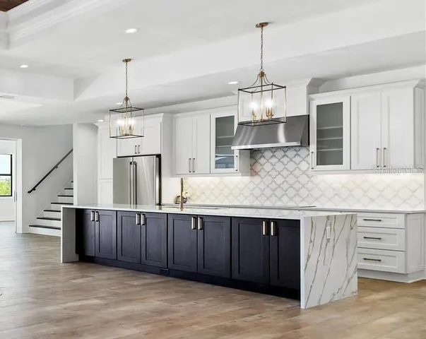 a kitchen with stainless steel appliances granite countertop cabinets a sink island and wooden floor