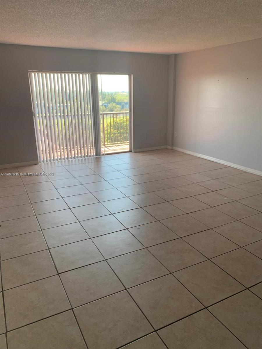 4174 Inverrary Drive, Unit 906 Lauderhill, FL 33319 - Photo 4 of 9 an empty room with windows