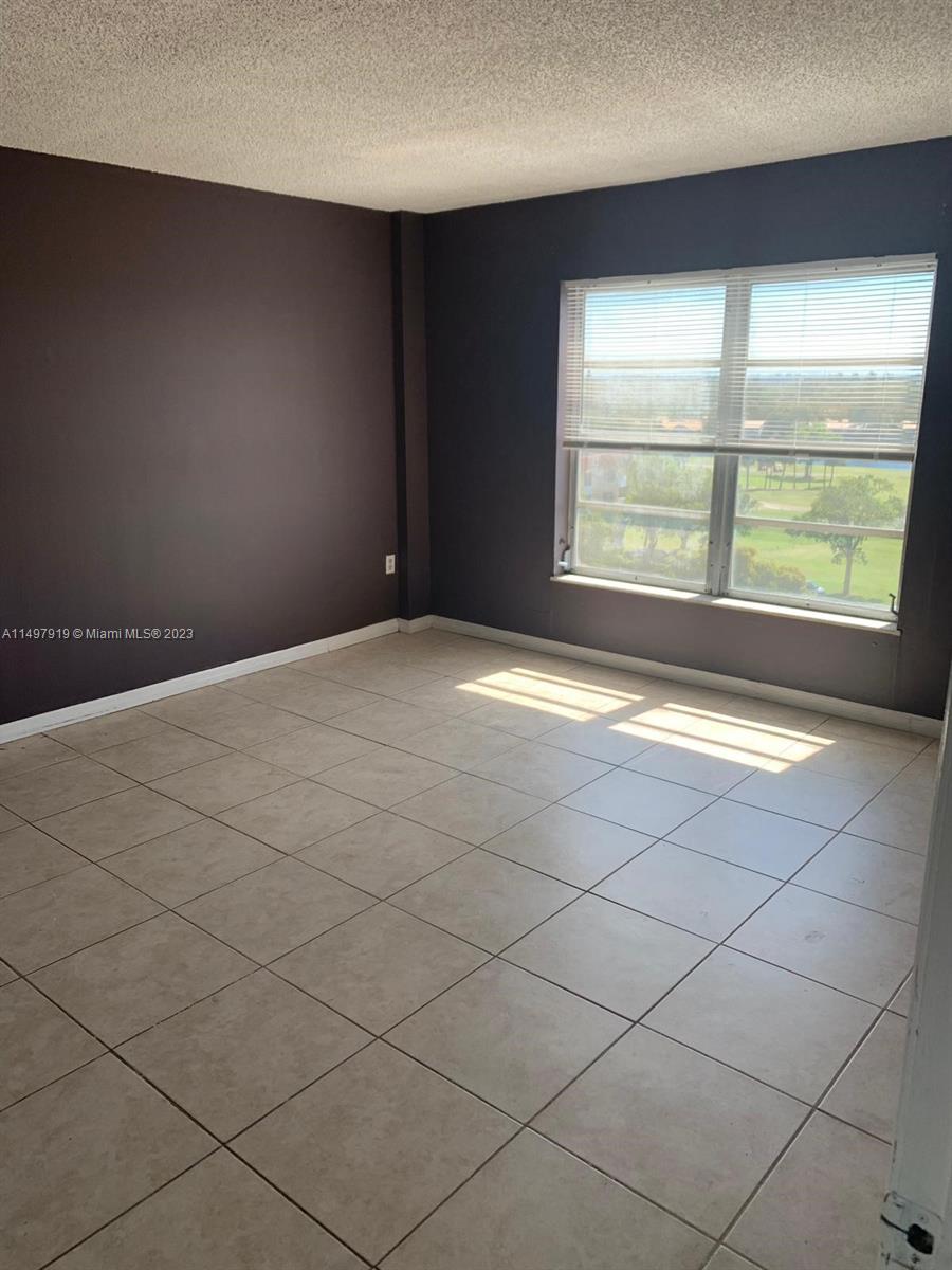 4174 Inverrary Drive, Unit 906 Lauderhill, FL 33319 - Photo 8 of 9 a view of an empty room with a window