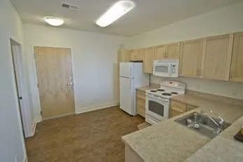 a kitchen with a stove a refrigerator and a sink