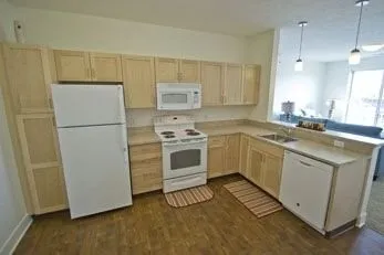 a kitchen with white cabinets and white appliances