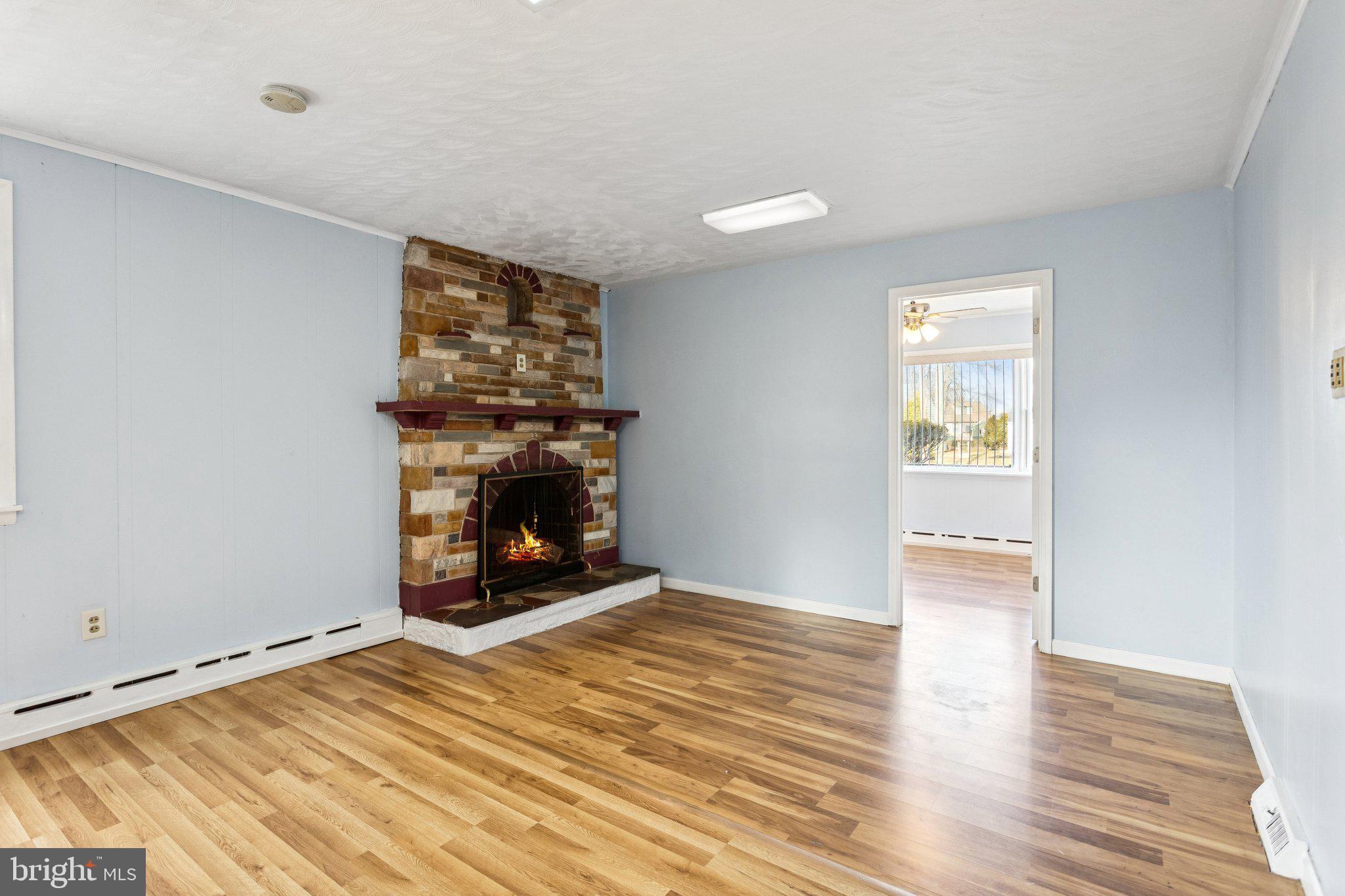 2614 Old Welsh Road Willow Grove, PA 19090 - Photo 30 of 47 an empty room with wooden floor fireplace and windows