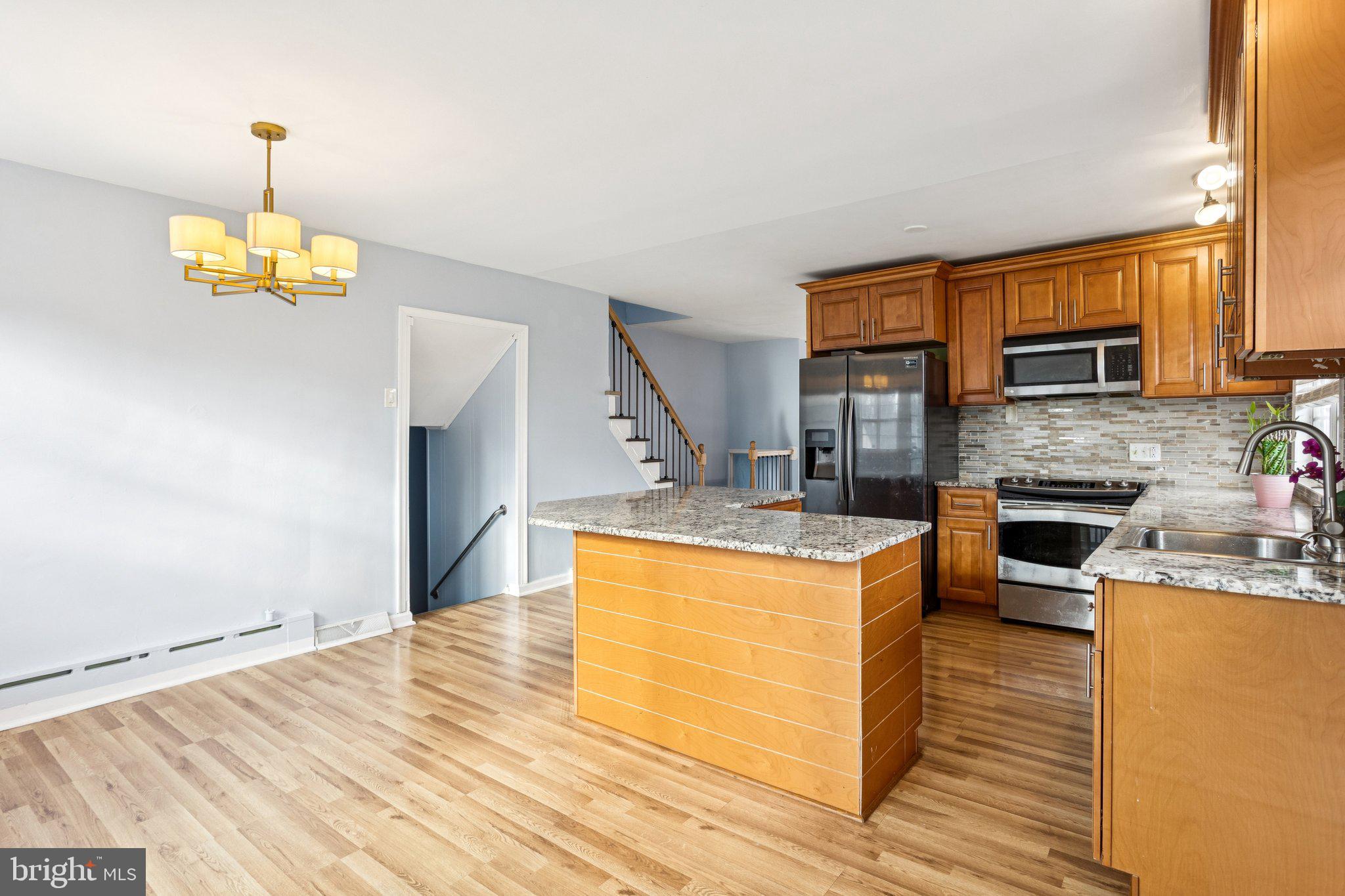 2614 Old Welsh Road Willow Grove, PA 19090 - Photo 10 of 47 a kitchen with stainless steel appliances granite countertop a sink a stove and a wooden floors