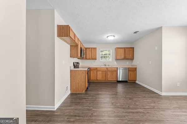 a view of a kitchen with a sink cabinets and wooden floor