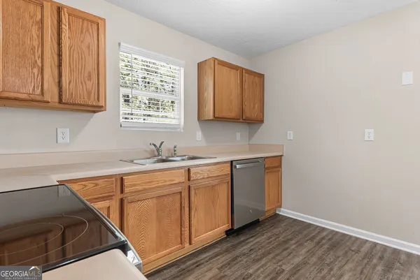 a kitchen with granite countertop white cabinets and sink