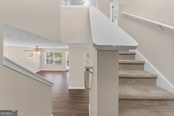 a view of entryway and hall with wooden floor