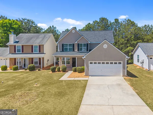 a front view of a house with a yard