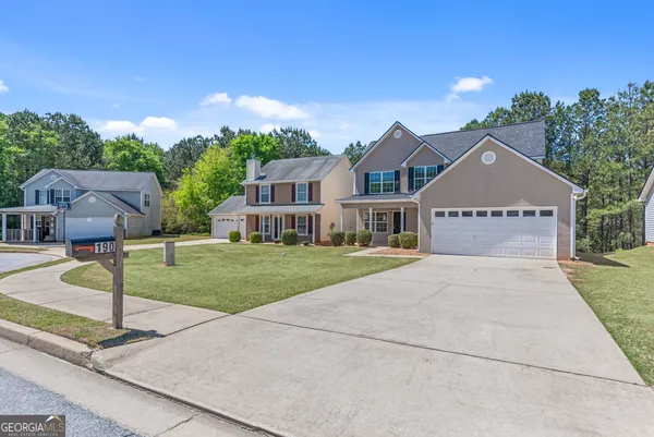 a front view of a house with a yard and garage