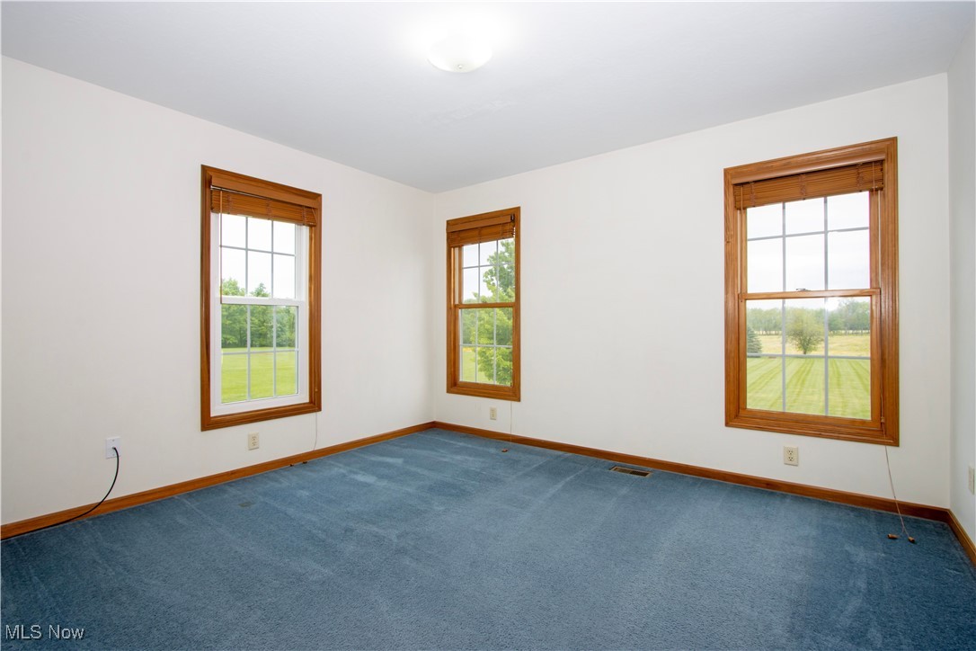 1500 Bell Road Wooster, OH 44691 - Photo 31 of 33 Carpeted spare room featuring baseboards and healthy amount of natural light