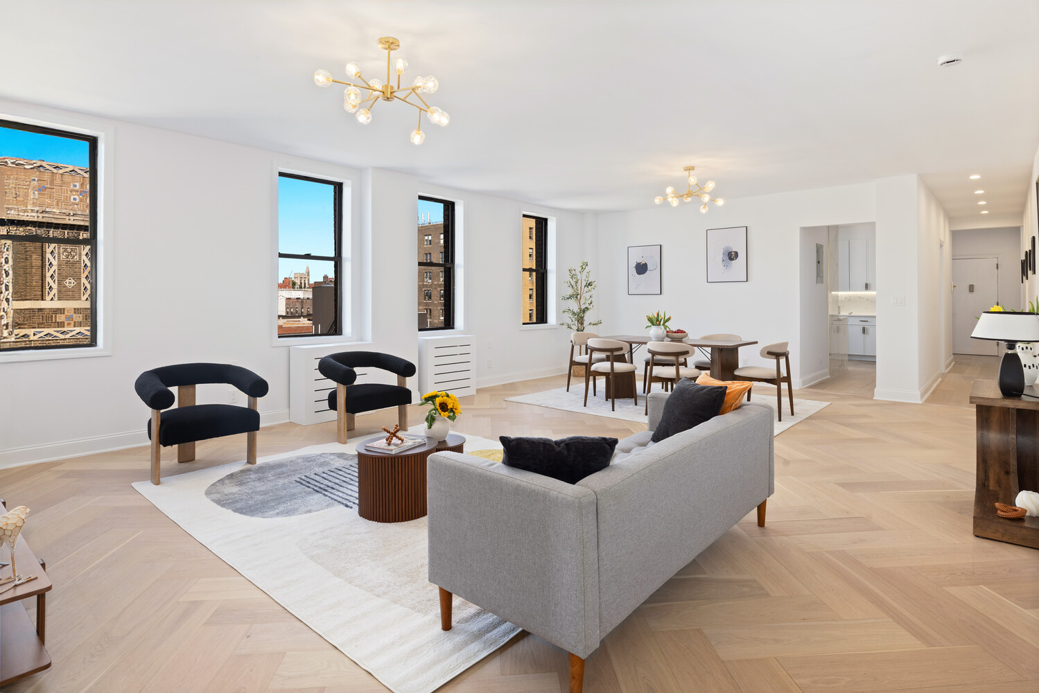 725 Riverside Drive, Unit 11A Manhattan, NY 10031 - Photo 1 of 21 a living room with furniture a chandelier a fireplace and a potted plant