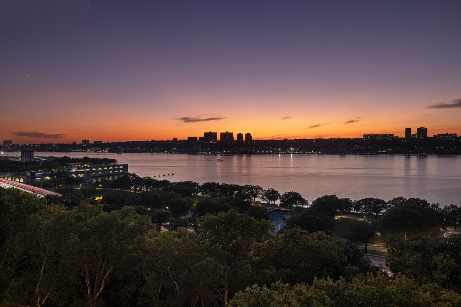 725 Riverside Drive, Unit 11A Manhattan, NY 10031 - Photo 13 of 21 a view of a lake in middle of sunset