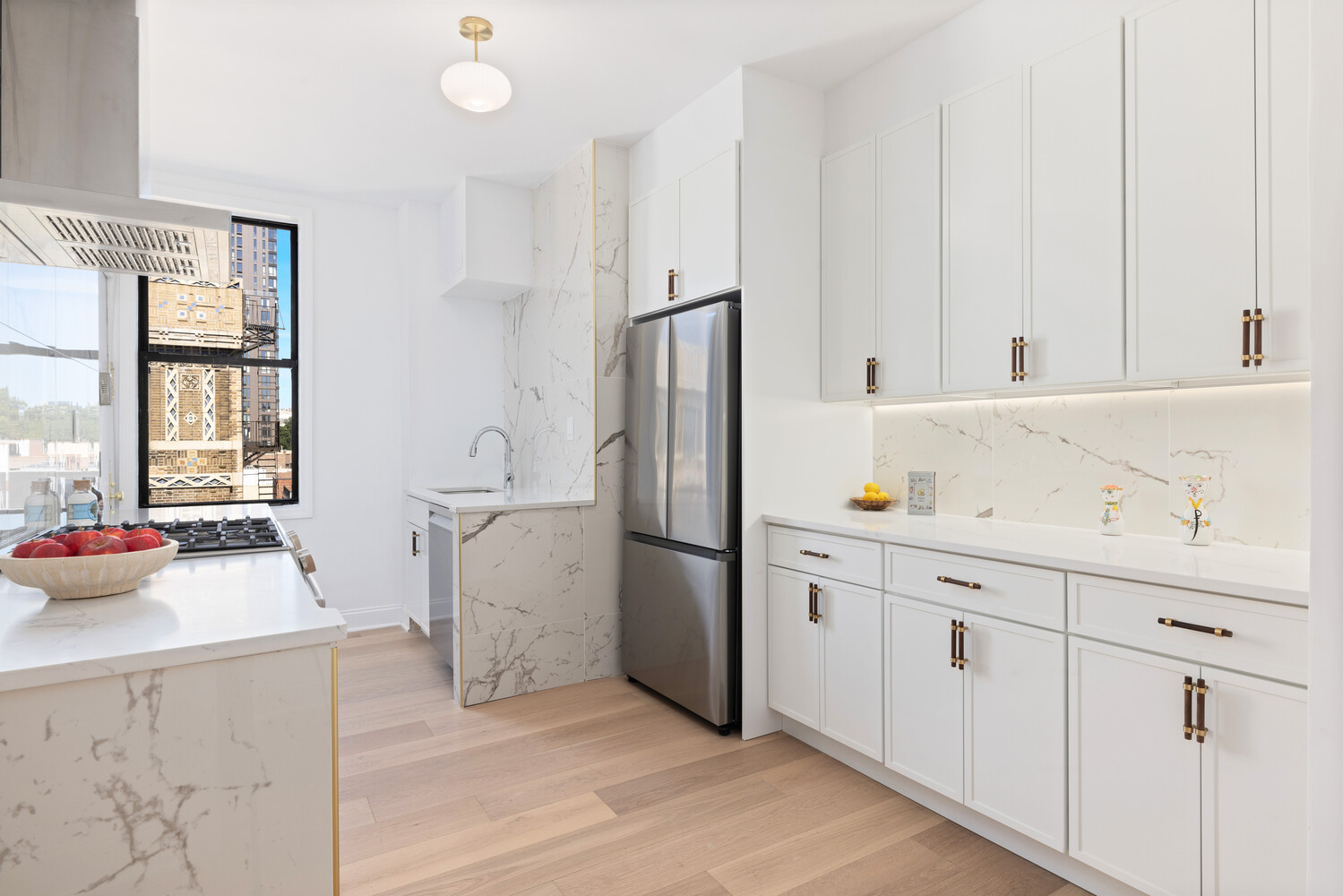 725 Riverside Drive, Unit 11A Manhattan, NY 10031 - Photo 5 of 21 a kitchen with a sink appliances and cabinets