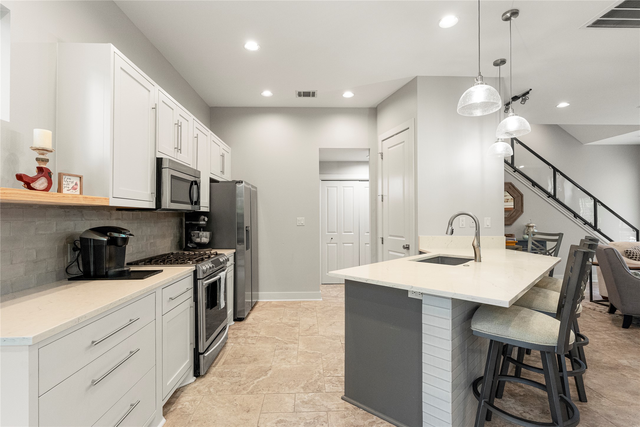 3814 Ridgelea Drive, Unit A Austin, TX 78731 - Photo 14 of 30 a kitchen with a sink stainless steel appliances and white cabinets