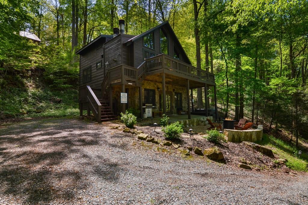 1213 Mountain Oak Road Ellijay, GA 30536 - Photo 2 of 65 a front view of a house with garden