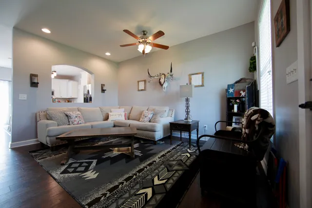 a view of a room with wooden floor cabinet and windows