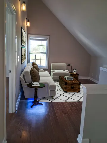an empty room with a window and wooden floor