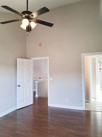 a view of a livingroom with wooden floor and a fireplace
