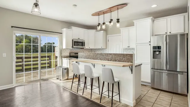 a kitchen with stainless steel appliances a refrigerator sink and microwave