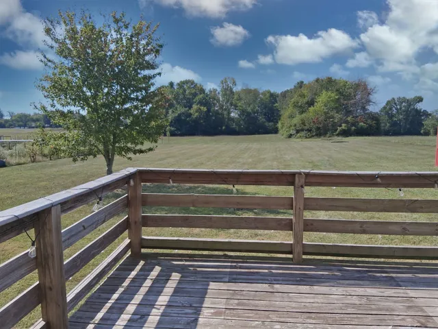 a kitchen with kitchen island granite countertop a stove a sink and a microwave
