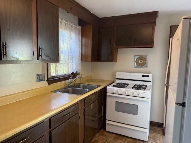 a kitchen with a sink stove and microwave