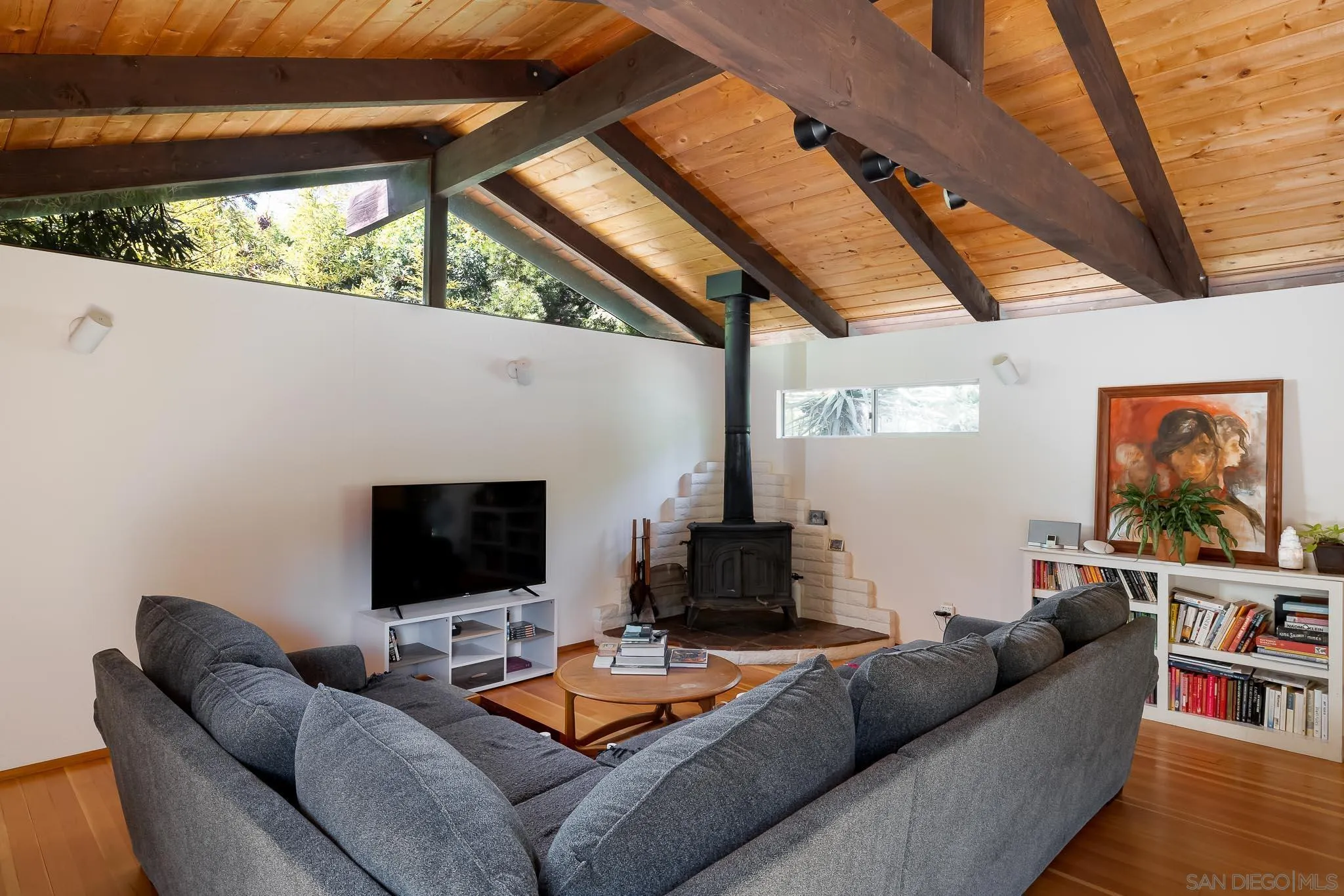 4880 Sun Valley Road Del Mar, CA 92014 - Photo 4 of 23 a living room with furniture a flat screen tv and a floor to ceiling window