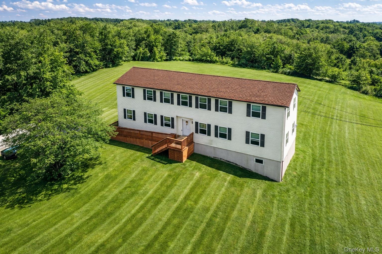 69 Old Unionville Road, Unit 4 Wallkill, NY 12589 - Photo 2 of 21 Aerial view of property and surrounding area with a forest