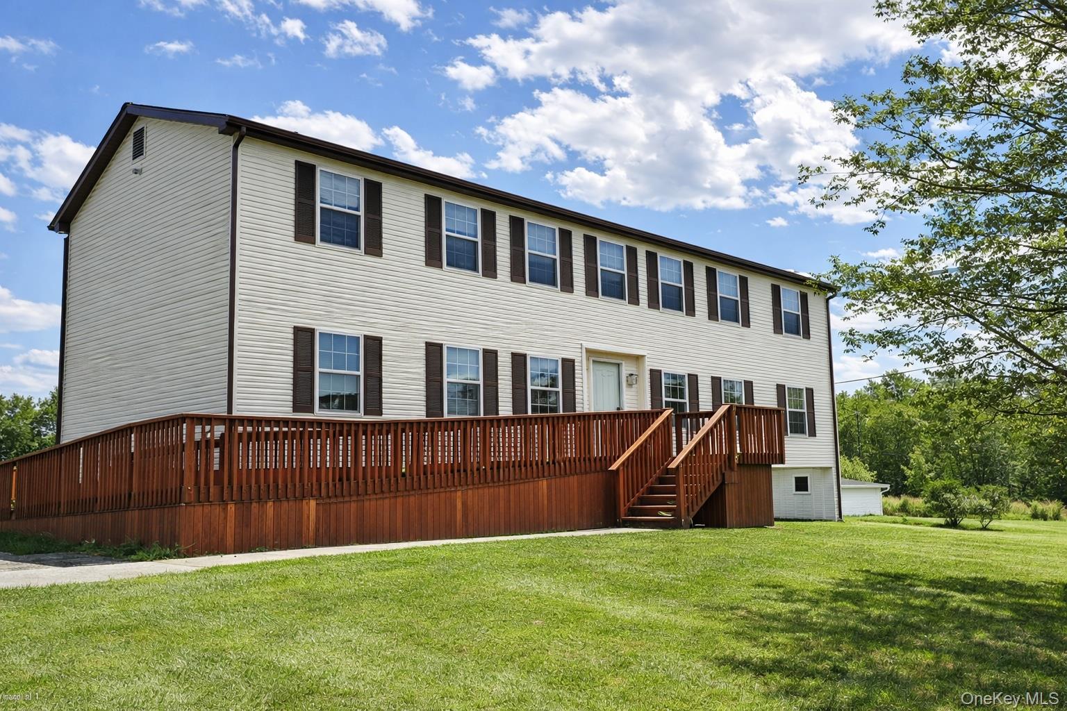 69 Old Unionville Road, Unit 4 Wallkill, NY 12589 - Photo 3 of 21 view of house with a wooden deck and a yard