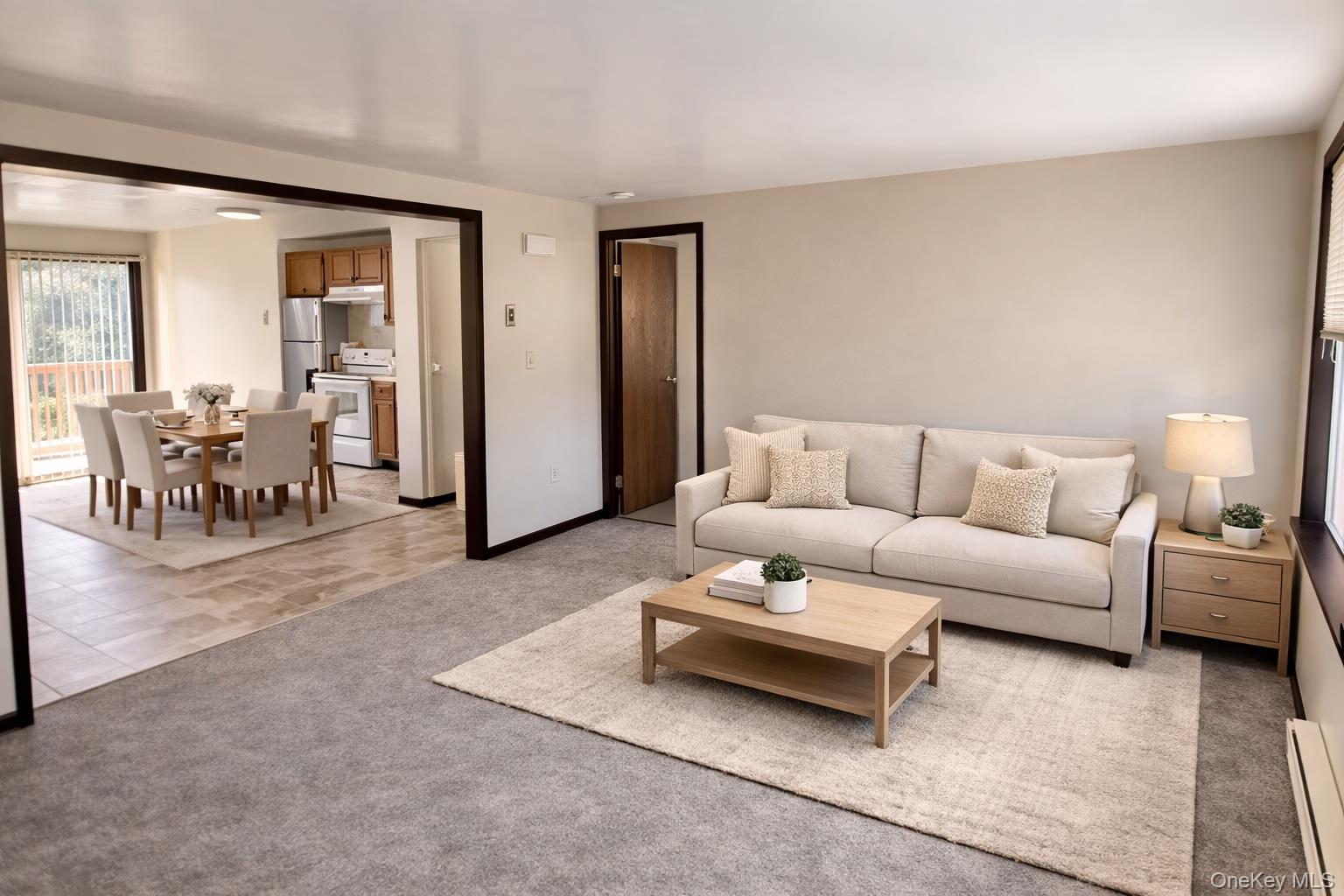 69 Old Unionville Road, Unit 4 Wallkill, NY 12589 - Photo 8 of 21 Living area featuring light colored carpet and a baseboard radiator
