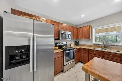 a kitchen with stainless steel appliances granite countertop a refrigerator and a sink