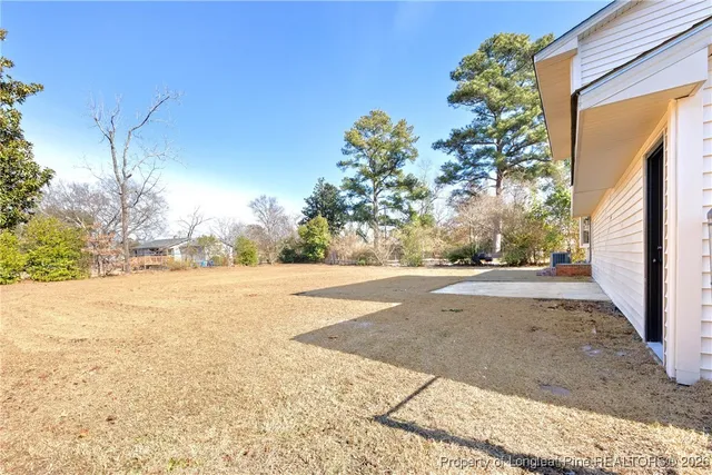 a view of a house with a yard covered with snow