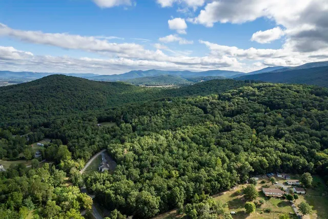 a view of a field with trees in the background