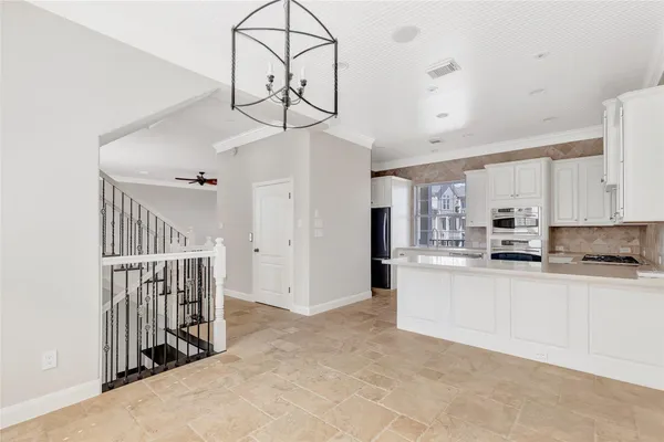 a kitchen with kitchen island granite countertop a refrigerator a stove a sink and dishwasher with wooden floor