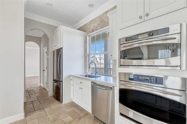 a kitchen with stainless steel appliances and cabinets