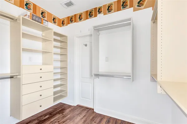a view of walk in closet with empty racks