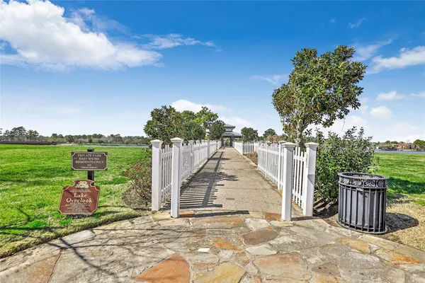 a view of a garden with a bench in front of house