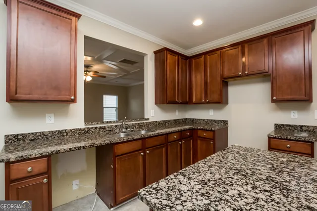 a kitchen with stainless steel appliances granite countertop a sink stove and cabinets