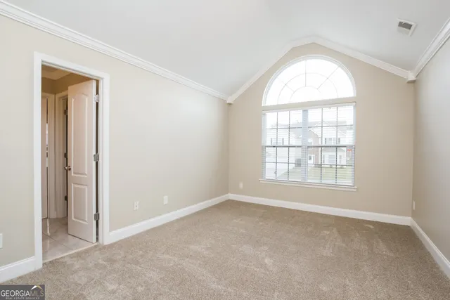 an empty room with windows and closet