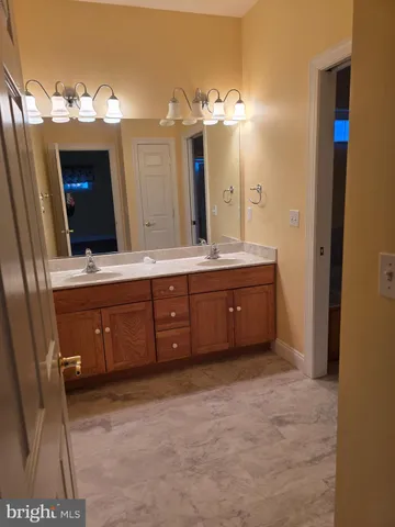 a spacious bathroom with a double vanity sink and a mirror