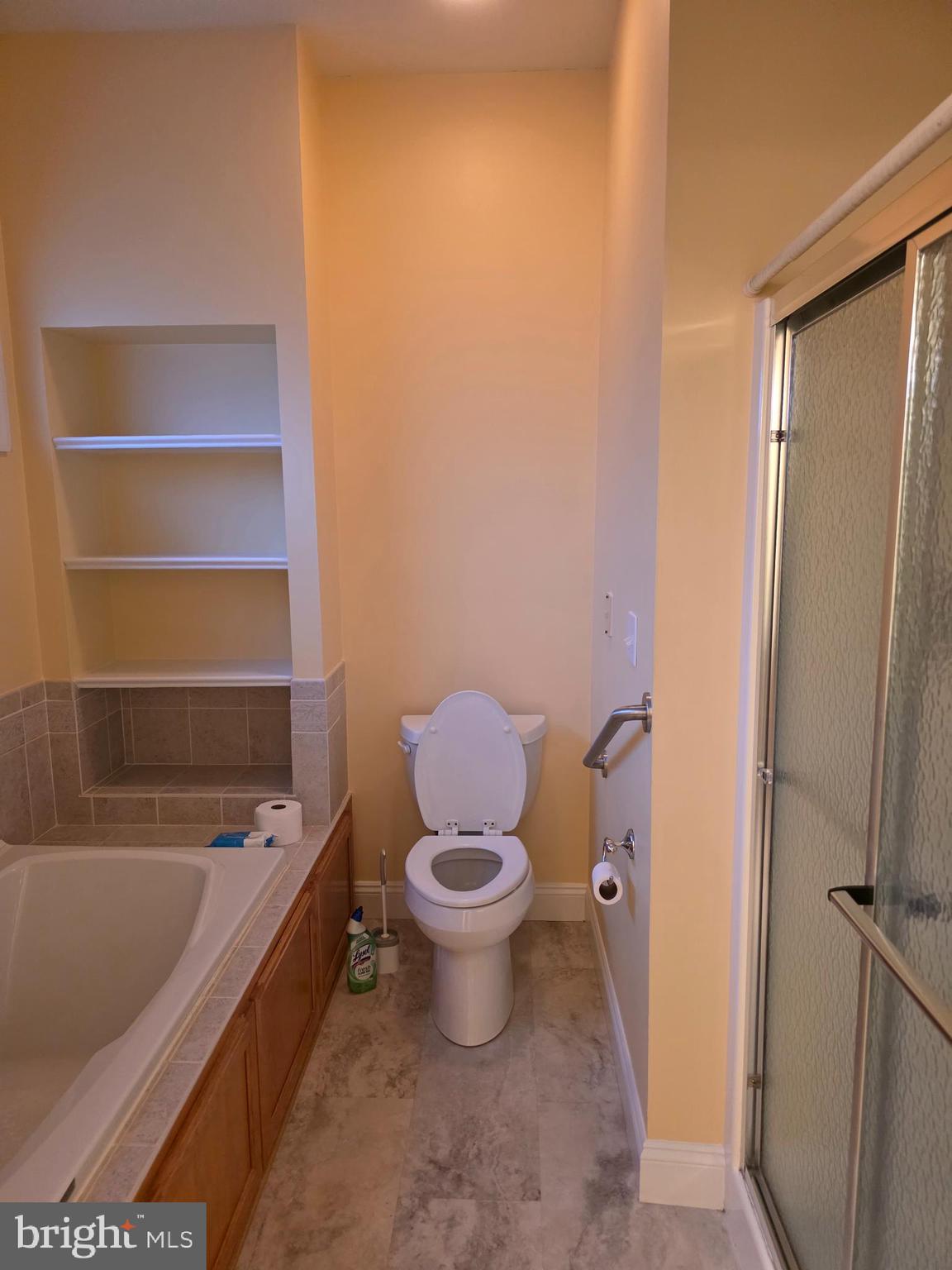 15 Bayberry Street Georgetown, DE 19947 - Photo 13 of 15 a bathroom with a granite countertop toilet and a bathtub