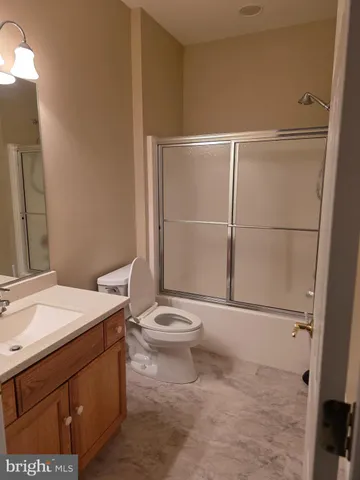 a bathroom with a toilet a sink and a mirror