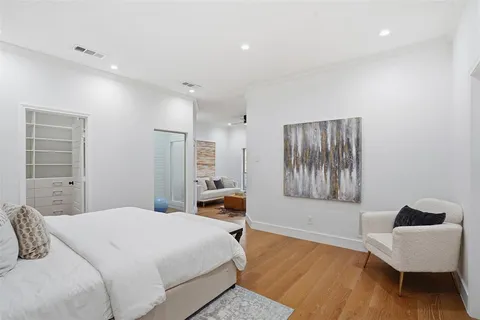 a bedroom with a bed and a chair